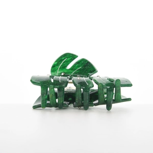 Close-up of emerald green marble leaf hair claw clip with sparkling rhinestones decoration