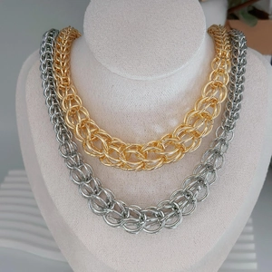 Street style U-shaped Cuban link necklaces in gold and silver plating shown on a bust model