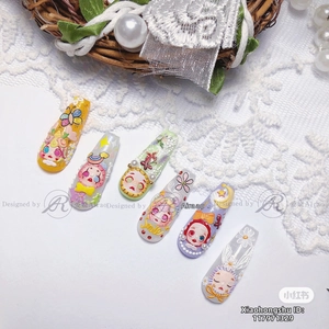 Detail of 3D embossed doll nail art stickers with cute character motifs and textures