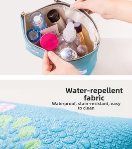 Detail of waterproof blue floral toiletry bag showing spacious interior and fabric texture