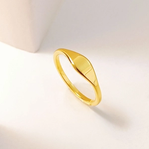 Detail view of a 18K gold plated minimalist signet ring with a smooth rectangular face