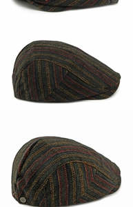 Detail of wool-like herringbone pattern fabric and bronze button on a flat cap