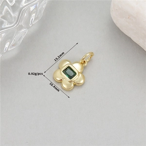 Détail du pendentif fleur dorée avec zircon vert, dimensions 15,2 mm x 10,4 mm