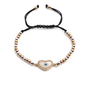 Detailed shot of woven cord bracelet featuring heart-shaped evil eye charm and tri-color beads