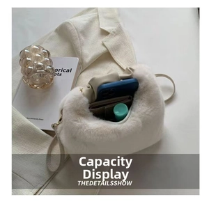 Spacious interior of white faux fur handbag showing room for phone and essentials