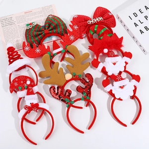 Christmas reindeer antler headbands with sequins and bows on a white festive background