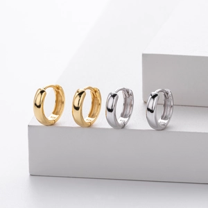 Detailed macro view showing the 925 sterling silver stamp on gold and silver hoop earrings