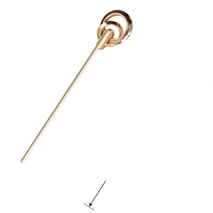 Detailed close-up of a golden metal hair pin featuring a unique double interlocking loop design