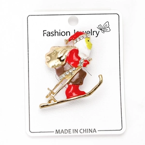 Detail of skiing Santa Claus Christmas brooch with red enamel and sparkling rhinestones