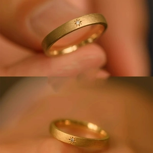 Macro shot of 18k gold plated matte starburst ring with a sparkling zircon inlay