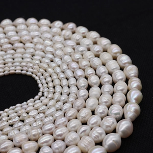 Detailed view of white baroque freshwater pearls with natural texture on black background
