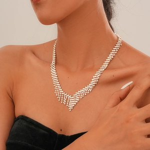 Close-up of sparkling silver rhinestone tassel necklace worn on model for elegant look
