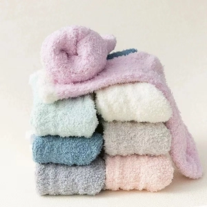 Thick coral fleece socks for women in soft pastel colors with cozy plush texture