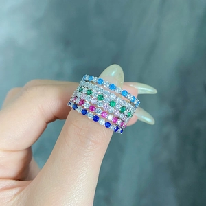 Close-up of four s925 silver rings set with colorful gemstone zircons on hand