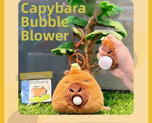 Detail of Capybara plush keychain showing the squeeze feature with a white bubble effect