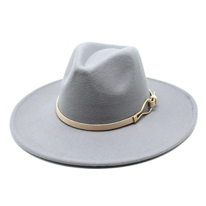 Detailed macro shot of light gray felt fedora hat with beige leather strap and gold buckle