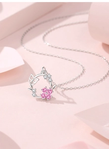Close-up of S925 silver necklace featuring a floral wreath with pink zircon and butterfly
