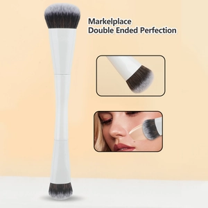 Detail of a double-ended makeup brush with white handle and gradient synthetic bristles