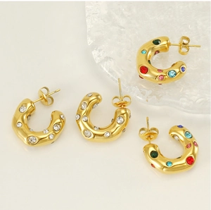 Detailed shot of 18K gold plated C-shaped earrings with colorful sparkling rhinestones