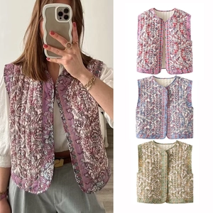 Detail view of quilted floral vest jackets in pink purple, blue and green colors