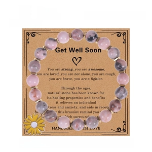 Pink zebra stone beaded bracelet with yellow daisy sunflower charm on display card