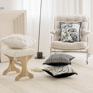 Assorted French style beige luxury throw pillows styled in a Nordic living room setting