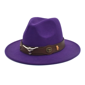 Detail of purple wool felt jazz hat featuring a brown leather band and silver bull head charm