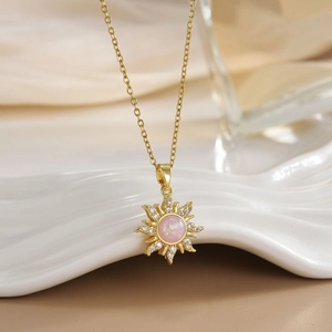 Gold-plated sun pendant necklace with pink opal center and micro-paved cubic zirconia
