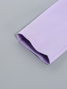 Detail shot of purple dress sleeve showing high-quality stitching and fabric texture
