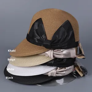 Close-up showing a stack of woven straw sun hats with elegant bow accents in various colors