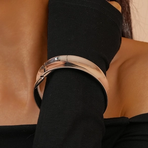 Close-up of minimalist polished silver geometric cuff bracelet worn on female wrist
