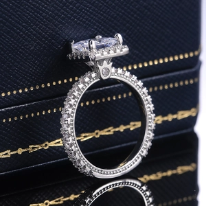 Macro view of square halo engagement ring with crown setting and micro pavé diamonds