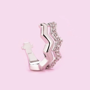 Detailed macro view of silver zigzag ear cuff featuring polished finish and pave zircon stones