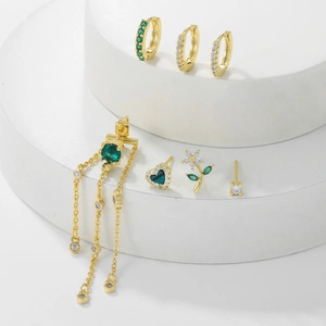 7-piece gold flower tassel earring set with green zircons on white geometric steps
