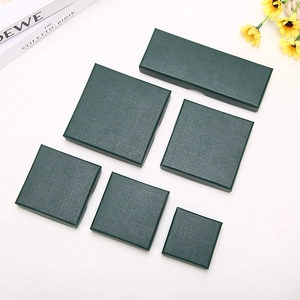 Deep green textured square jewelry gift box set displayed on a white professional background
