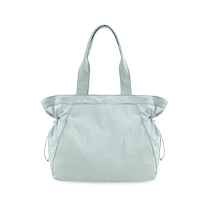 Detail view of light blue waterproof yoga tote bag with functional side drawstring design