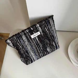 Retro denim brushed makeup bag with black and white woven stripes and zipper closure