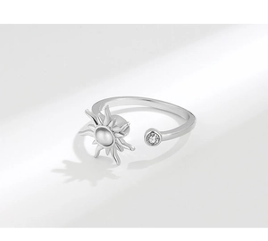Macro detail of rotating silver sunflower ring with sparkling zircon and adjustable band