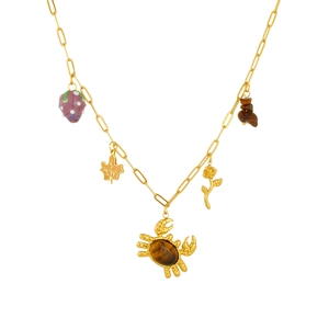 Gold chain necklace with tiger eye stone crab, maple leaf and rose charms on white background