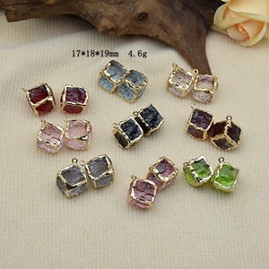 Macro detail of colorful resin cube pendants with gold plated edges for DIY jewelry
