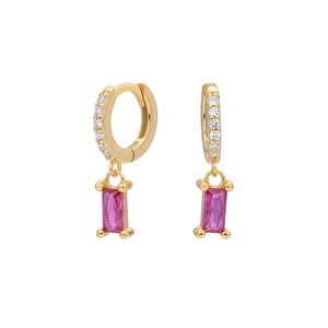Macro view of gold hoop earrings featuring white zircon and rectangular red stones