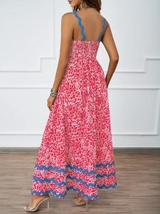 Detail of smocked elastic back and red spotted print on a bohemian summer maxi dress