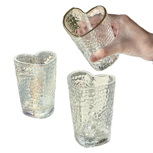 Minimalist heart-shaped glass cup with hammered texture and elegant gold rim details