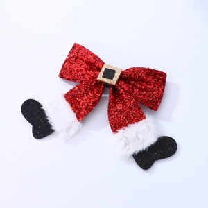 Nahaufnahme der roten Glitzer-Weihnachtsschleife mit Plüsch und schwarzem Stiefel