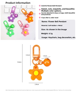 Detail view of colorful soft rubber flower bell keychain showing size and lobster clasp