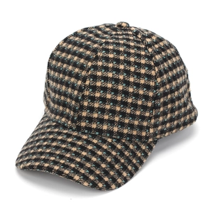 Detail of tweed check baseball cap showing black and beige woven fabric with blue accents
