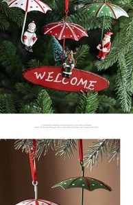 Close-up of metal Santa and snowman parachute hanging ornaments with Welcome sign