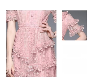 Detailed close-up of pink lace embroidery and layered ruffle hem on summer dress