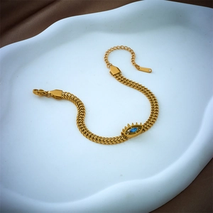 Golden titanium steel evil eye bracelet with blue marquise stone on a wheat chain