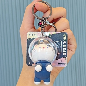 Deep blue astronaut cat keychain with silicone spacesuit and a Cool Bear card